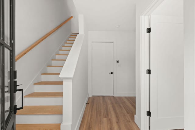 stairs with wood-type flooring