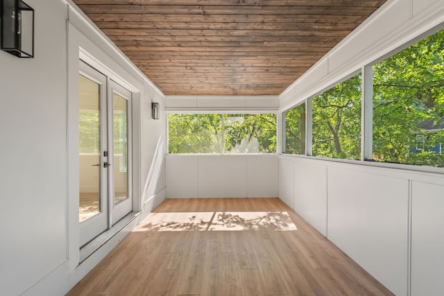 unfurnished sunroom featuring plenty of natural light and wood ceiling