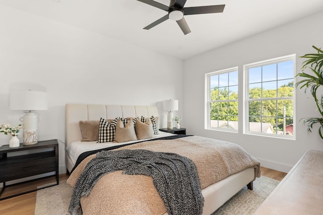 bedroom featuring light wood-type flooring and ceiling fan