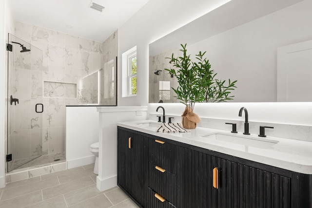 bathroom featuring walk in shower, vanity, tile patterned flooring, and toilet