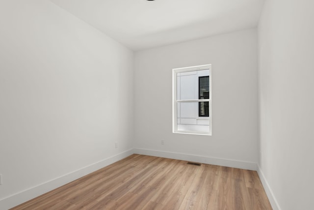 unfurnished room with light wood-type flooring