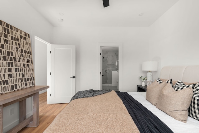 bedroom featuring ceiling fan, connected bathroom, and hardwood / wood-style floors