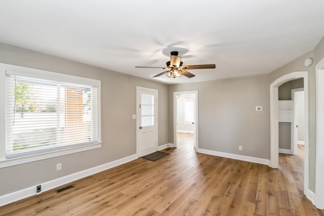 empty room with light hardwood / wood-style flooring and ceiling fan