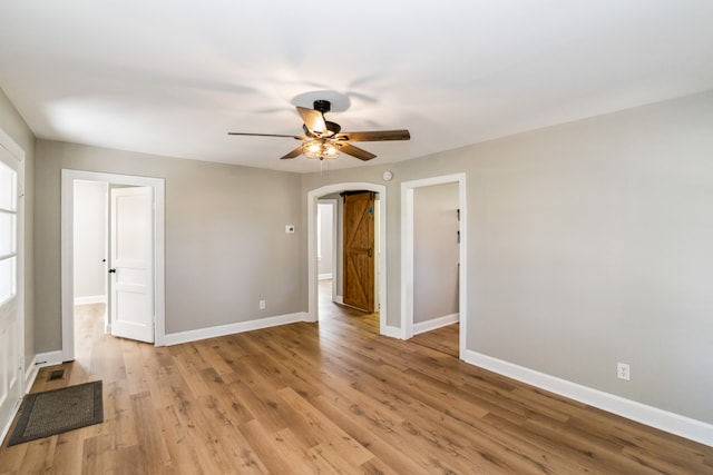 empty room with light wood-type flooring and ceiling fan