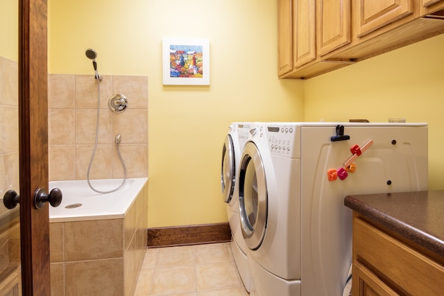 washroom with light tile patterned flooring and washing machine and dryer