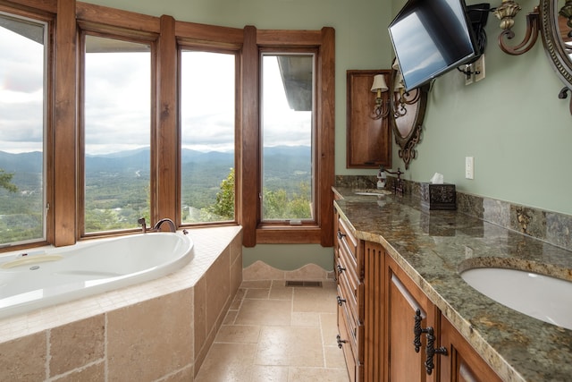 bathroom with vanity, a mountain view, and plenty of natural light