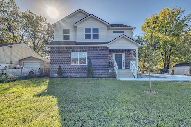 view of front property featuring a front yard, an outdoor structure, and a garage