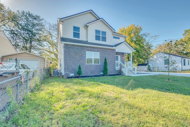 view of front of house featuring a front yard, a garage, and an outbuilding