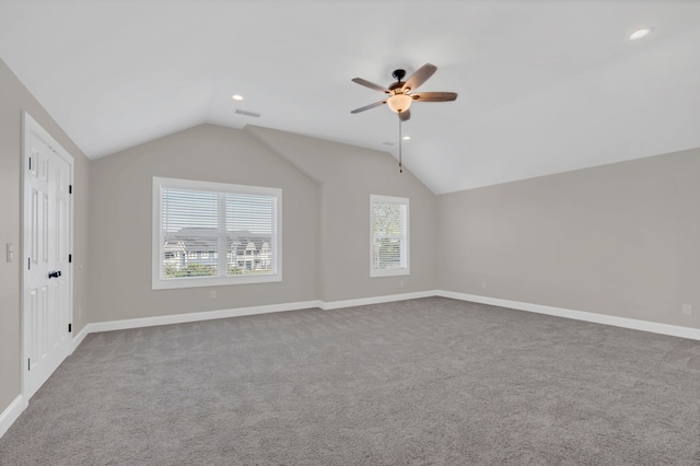 additional living space with vaulted ceiling, carpet flooring, and ceiling fan