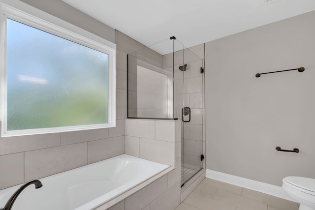 bathroom with tile patterned flooring, separate shower and tub, and toilet