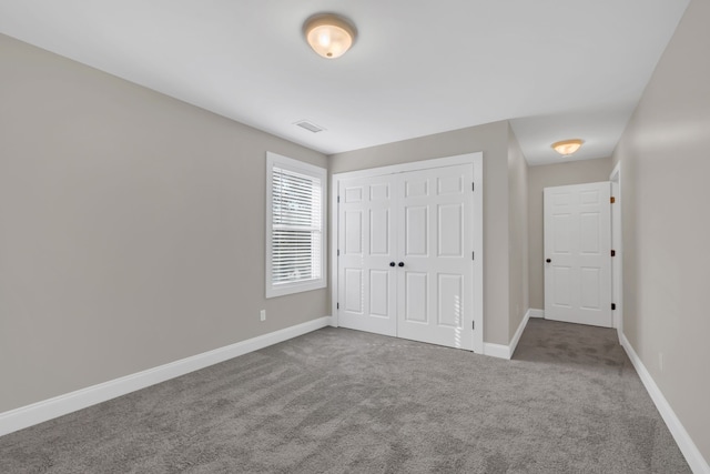 unfurnished bedroom featuring a closet and carpet flooring