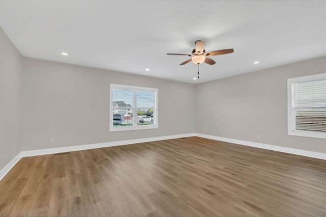 spare room featuring ceiling fan and light hardwood / wood-style floors