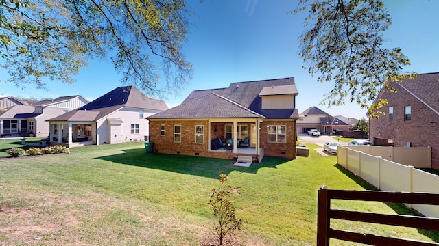 back of house featuring a lawn