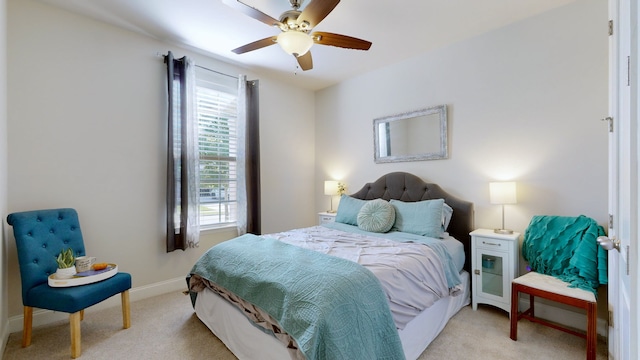 bedroom with light carpet and ceiling fan