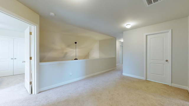 bonus room with light colored carpet