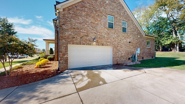 view of side of home with a lawn and a garage