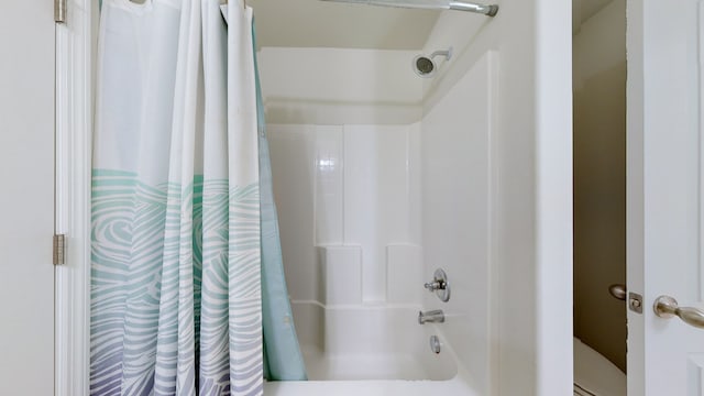 bathroom with shower / bath combo and toilet