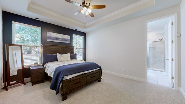 carpeted bedroom featuring ensuite bathroom, multiple windows, and ceiling fan