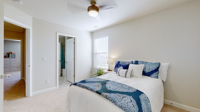 carpeted bedroom featuring ensuite bathroom and ceiling fan