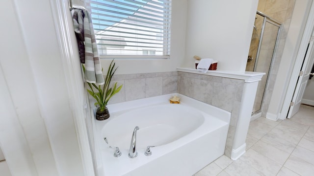 bathroom featuring tile patterned floors and separate shower and tub