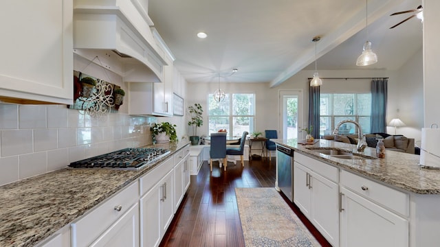 kitchen with sink, dark hardwood / wood-style flooring, white cabinetry, stainless steel appliances, and custom range hood