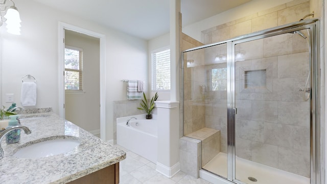 bathroom with vanity, independent shower and bath, tile patterned floors, and plenty of natural light