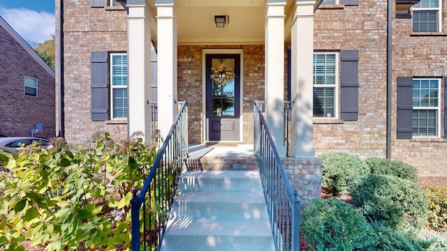 view of exterior entry featuring a porch