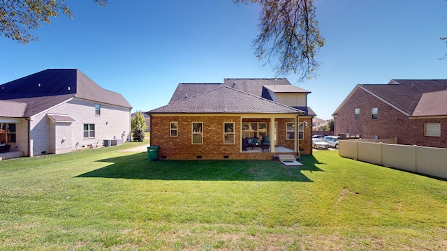 back of property featuring a patio, a yard, and central AC unit