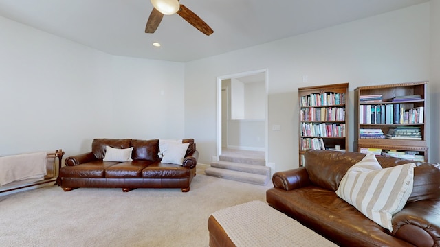 living room featuring light carpet and ceiling fan