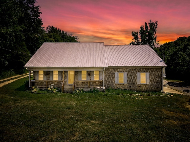 view of front of property with a yard and covered porch