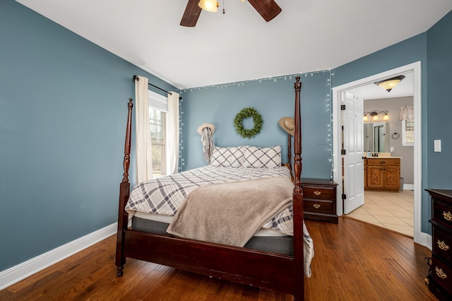 bedroom with wood-type flooring, ensuite bath, and ceiling fan