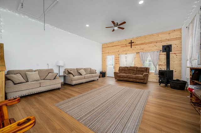 living room featuring wood-type flooring and wooden walls