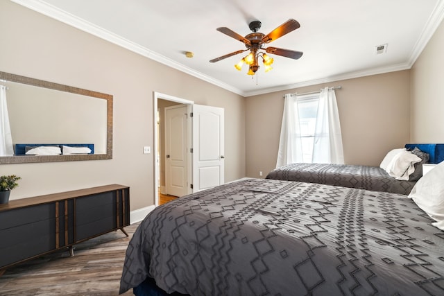 bedroom featuring ceiling fan, wood-type flooring, and ornamental molding