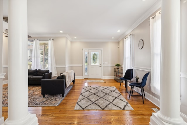 entryway featuring hardwood / wood-style flooring, a healthy amount of sunlight, and crown molding