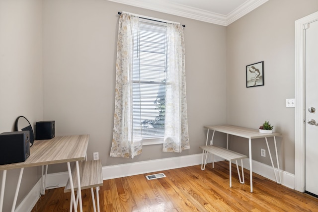 office area featuring hardwood / wood-style floors and crown molding