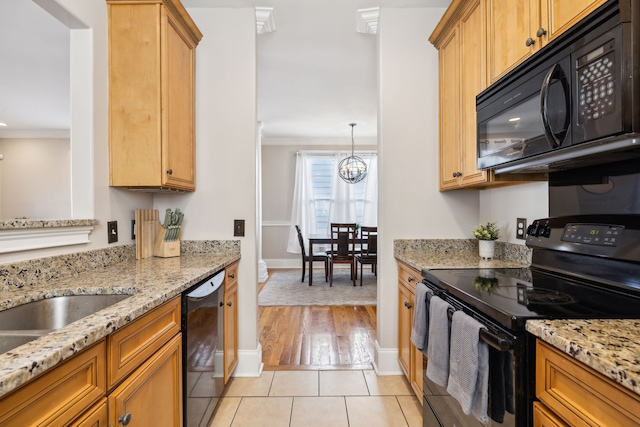 kitchen with light stone countertops, crown molding, a chandelier, light hardwood / wood-style floors, and black appliances