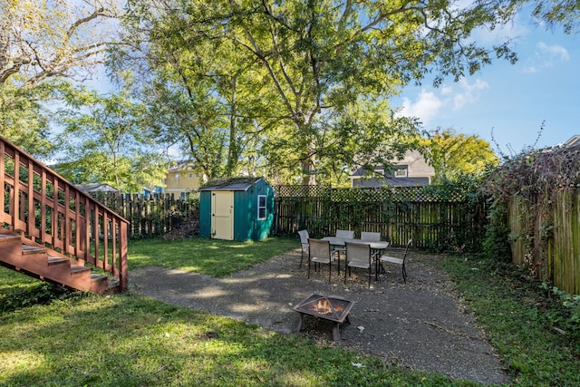 view of yard with a fire pit and a storage shed