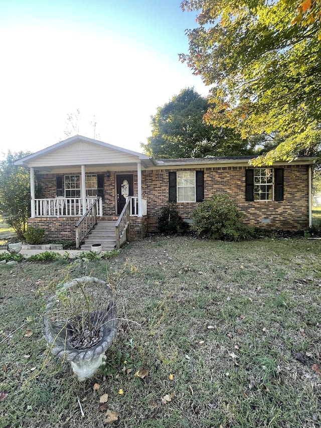 single story home with a porch and a front yard