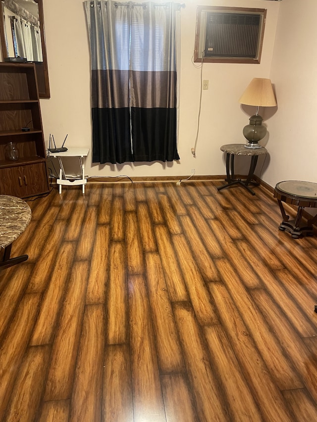 interior space featuring hardwood / wood-style floors and a wall mounted AC