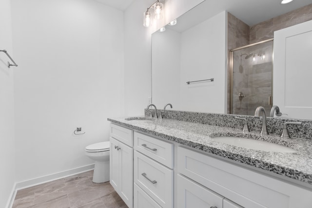 bathroom featuring an enclosed shower, vanity, and toilet