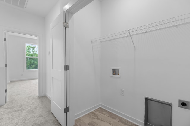 washroom featuring light carpet, hookup for an electric dryer, and hookup for a washing machine