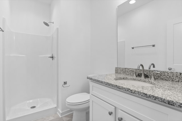 bathroom with a shower, vanity, and toilet