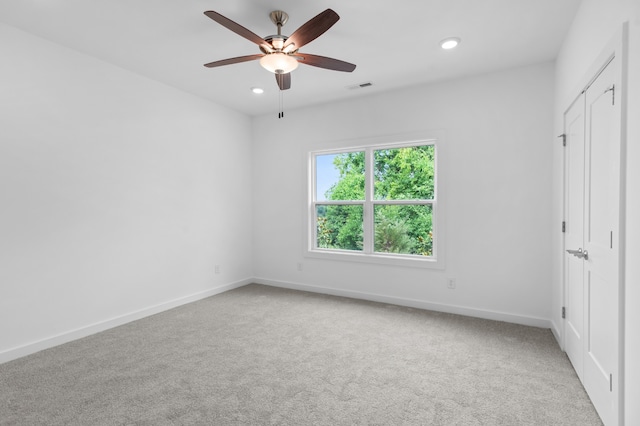 spare room featuring ceiling fan and carpet flooring