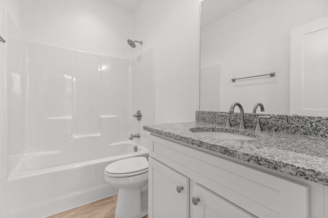 full bathroom with shower / bath combination, hardwood / wood-style floors, vanity, and toilet