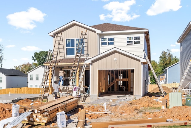 rear view of house with a garage