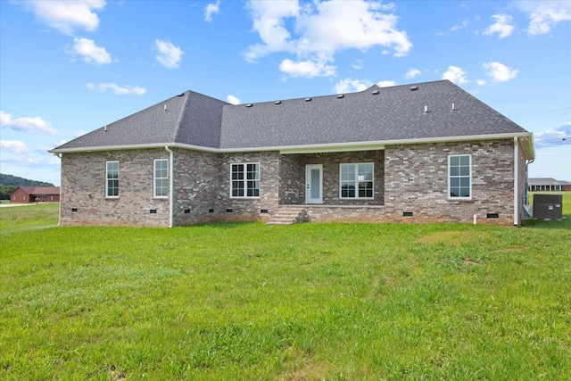 rear view of house featuring a lawn