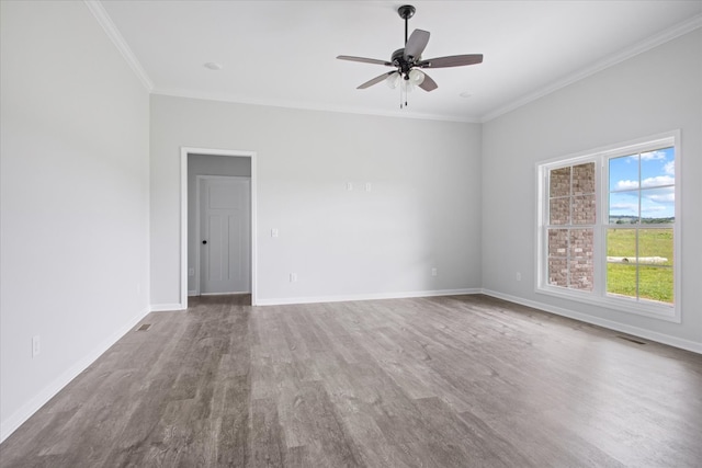 spare room with ornamental molding, ceiling fan, and wood-type flooring