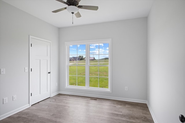 empty room featuring light wood-type flooring and ceiling fan