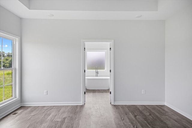 empty room featuring hardwood / wood-style floors and a healthy amount of sunlight