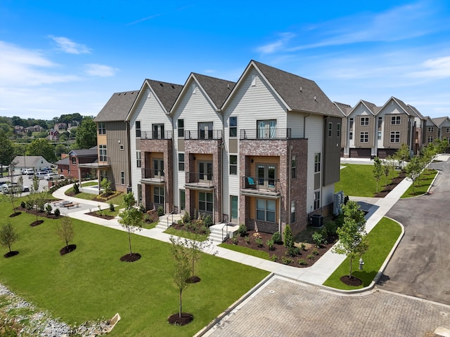 view of front of property with cooling unit and a balcony